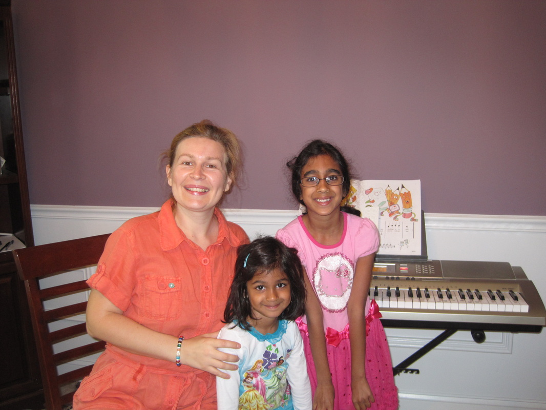 Piano Teacher and Girl Students